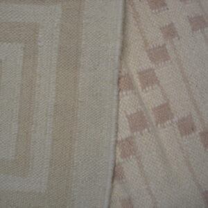 Close-up showing two woven rug patterns: beige geometric key design and cream with taupe squares.