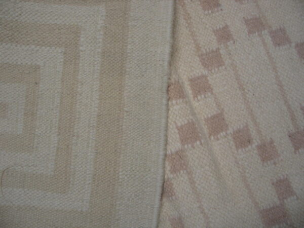 Close-up showing two woven rug patterns: beige geometric key design and cream with taupe squares.