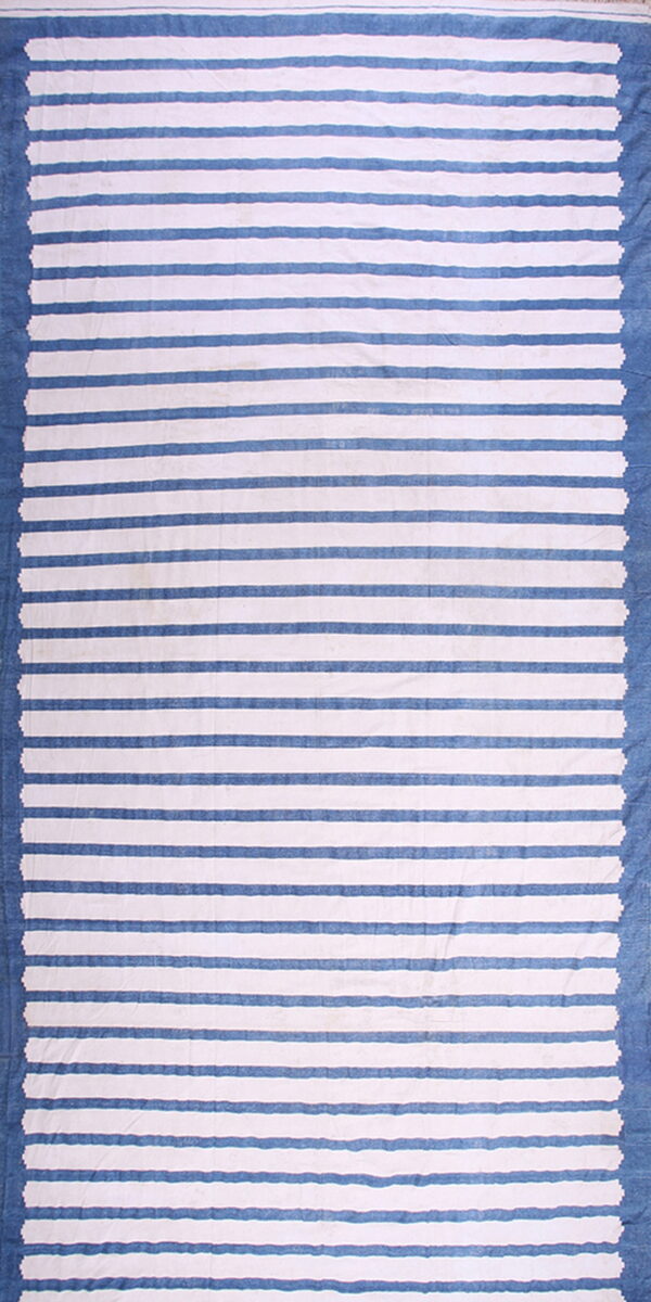 Blue and white striped flatweave rug showing solid blue borders and jagged interior edges.