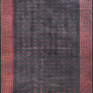 Charcoal gray rug featuring red dotted motifs and a wide, geometric Greek Key border.