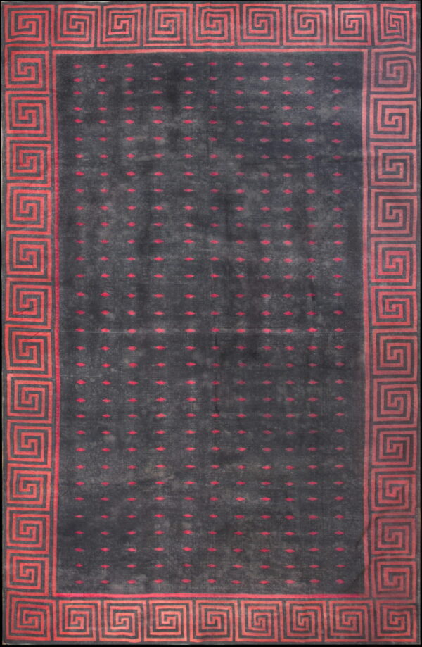 Charcoal gray rug featuring red dotted motifs and a wide, geometric greek key border.