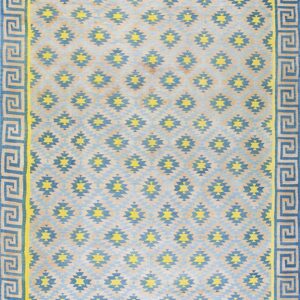 Blue and yellow geometric rug featuring stepped diamond motifs and a wide Greek key border design.