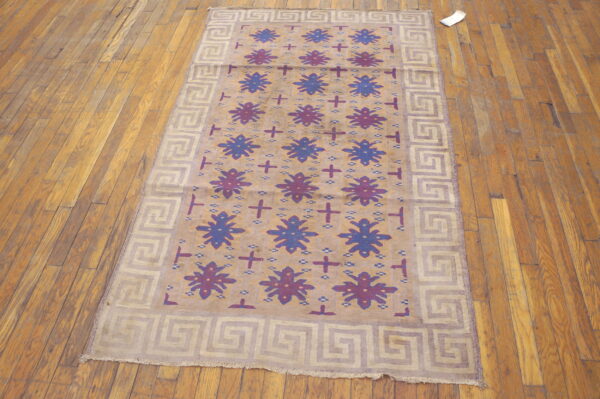 Antique dhurrie small scatter size cotton brown rug 1 Beige rug featuring alternating blue and purple floral medallions and a greek key border on wood floor.