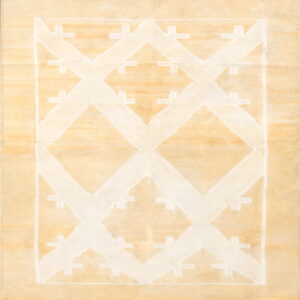 Pale beige rug featuring a prominent white geometric pattern of stepped diamonds and repeating cross shapes.