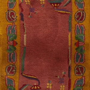 Deep rose rectangular rug with a wide mustard yellow border and multi-colored traditional vase motifs.
