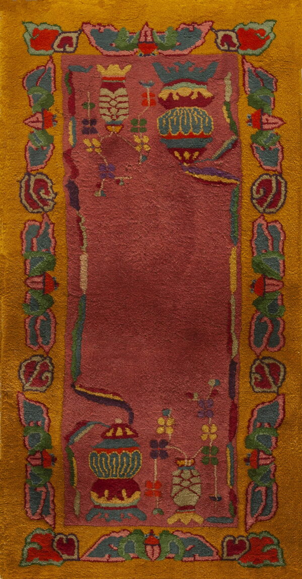 Deep rose rectangular rug with a wide mustard yellow border and multi-colored traditional vase motifs.