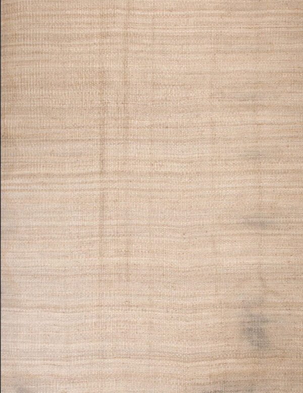 Close-up of a neutral beige flatwoven rug with horizontal texture and low pile.