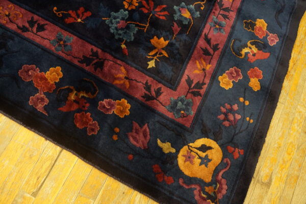 High-pile rug with navy, red, gold, and teal floral patterns, resting on bright yellow wood flooring.