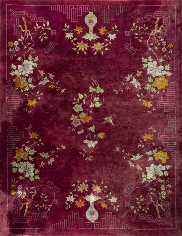 Crimson rug with a lustrous pile, featuring pale green and gold floral sprays and geometric border motifs.