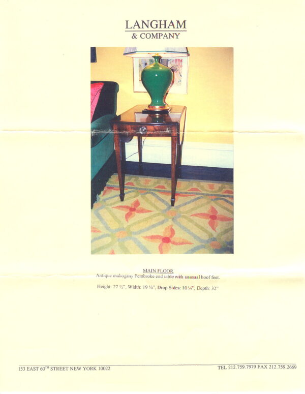 Low-pile rug featuring orange florals and light green lattice pattern under a dark wood end table.