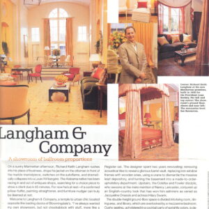 A subtle yellow and orange patterned rug fills a grand room decorated with antique-style furniture.