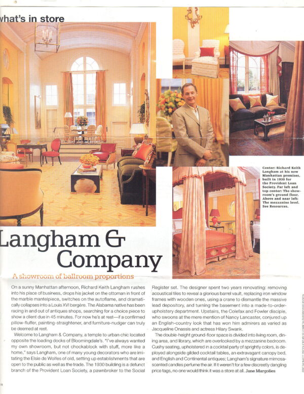 A subtle yellow and orange patterned rug fills a grand room decorated with antique-style furniture.