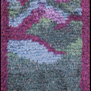 A shaggy, long-pile rug with a vibrant abstract pattern in magenta, dark purple, teal, and blue.