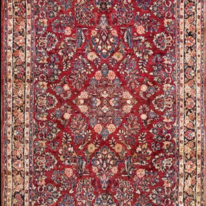 Low pile runner rug featuring an intricate traditional floral pattern on a rich burgundy field and cream borders.
