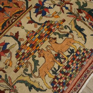 Detailed beige rug featuring colorful checkered geometry, tan leaping felines, and stylized red and blue designs.