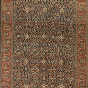 Navy and rust patterned rug featuring an all-over intricate design and a wide terracotta border.