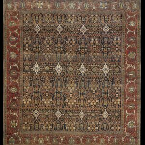 Square rug with a navy and gold floral trellis field and a wide rust-red border featuring stylized palmettes.