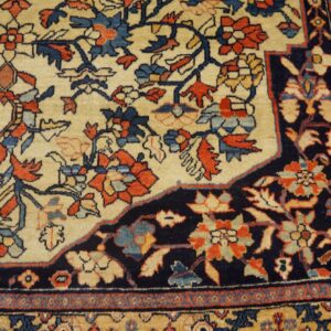 Ornate traditional rug showing a cream field, dark navy corner, and detailed red, blue, and gold floral designs.