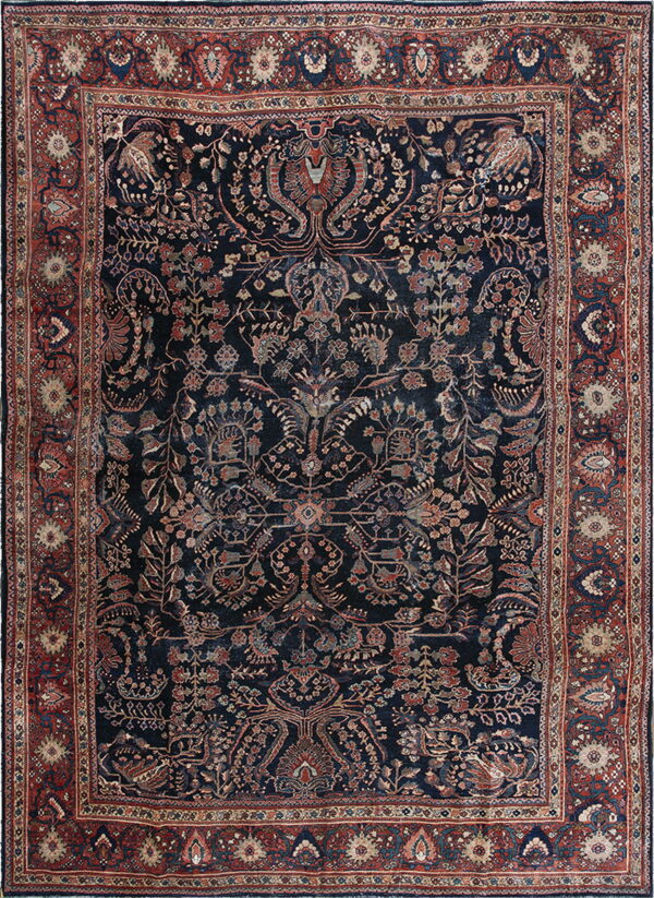 Deep navy rug with intricate floral and animal motifs and a wide rust red border.