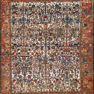 Intricate Tree of Life pattern rug with a white background and deep red borders, showing wear.