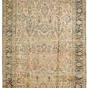 Pale pink and beige rug with dense blue floral designs and a wide, contrasting navy blue border.