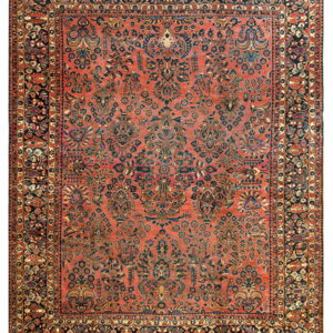 Terracotta rug with an intricate navy and rust floral design, bordered by multiple dark bands.