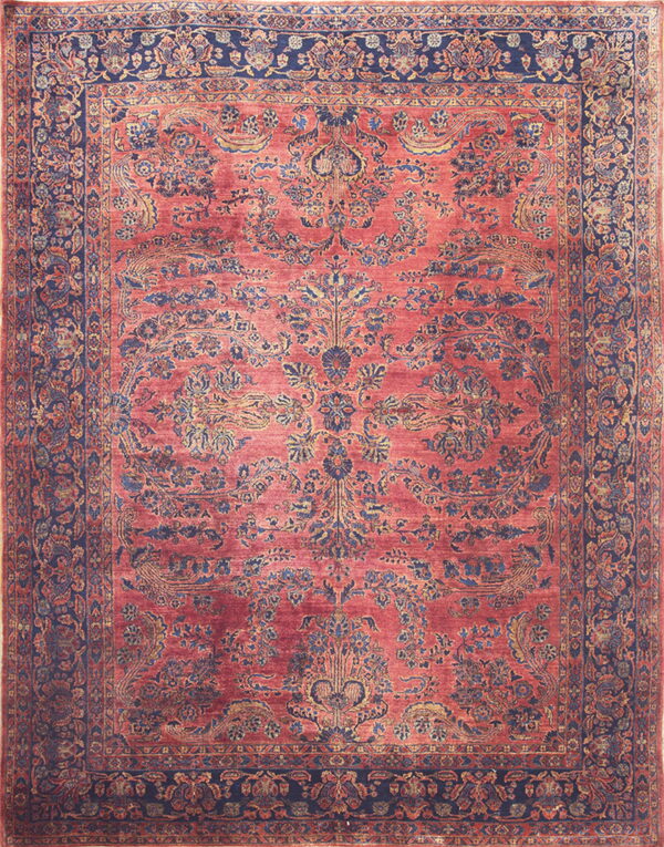 Ornate red rug with a low pile and complex blue and gold botanical patterns and borders.