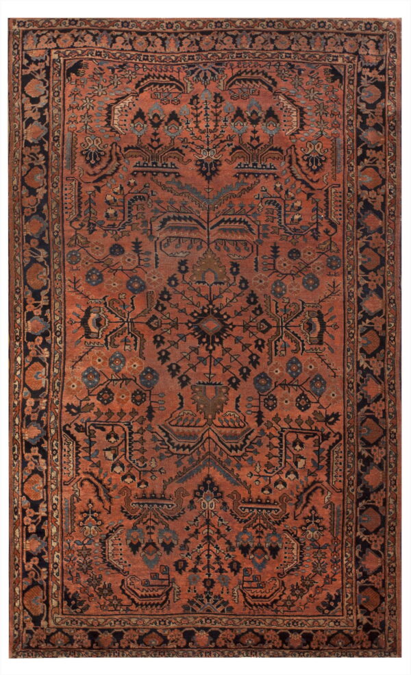 Rust colored rug with intricate dark navy borders and a central field of geometric and stylized floral patterns.