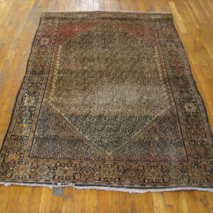 Worn antique rug with intricate patterns.