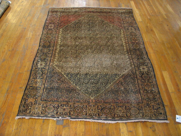 Worn antique rug with intricate patterns.