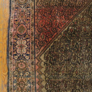 Intricate patterns on aged wool rug