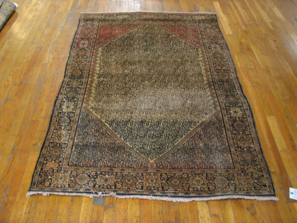 Worn antique rug with intricate patterns.