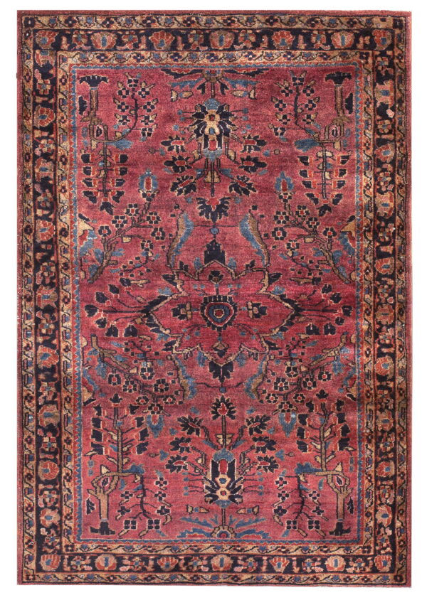 Muted red rug with complex floral designs and a medallion pattern in blue, navy, and tan.