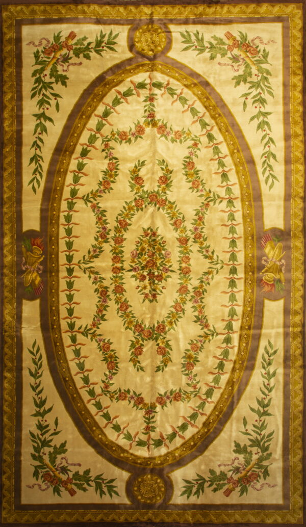 Ornate cream rug featuring an oval brown border frame and garlands of rose and green flowers.