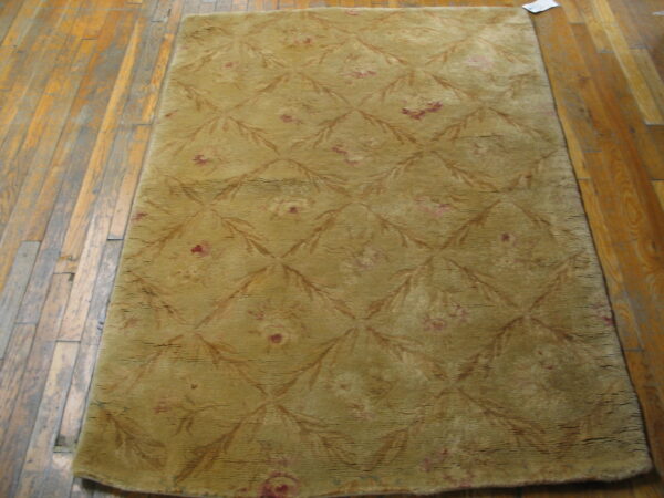 Textured yellow rug with floral pattern