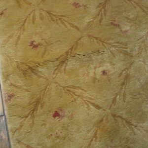 Textured yellow rug with floral pattern