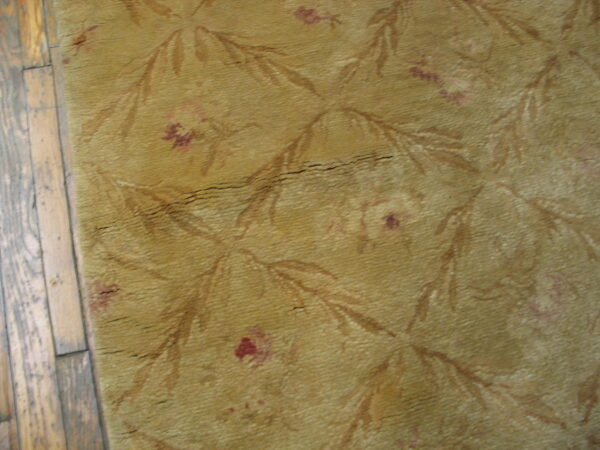 Textured yellow rug with floral pattern