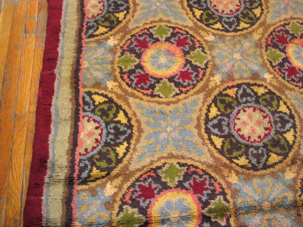 High pile rug featuring multicolored circular medallions and floral motifs rests on hardwood planks.