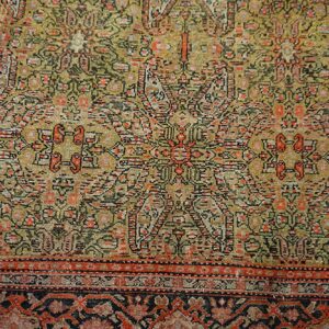 Low-pile rug with geometric patterns in faded olive, gold, red, black, and multiple borders.