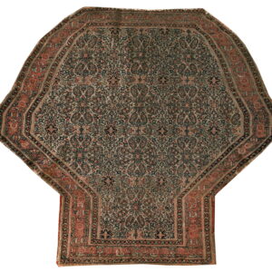 Octagonal rug with a niche extension, featuring detailed dark blue, beige, and terracotta floral patterns.