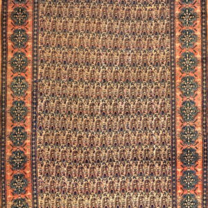 Rectangular rug with a light tan field of repeating motifs and a salmon-colored border of dark blue medallions.