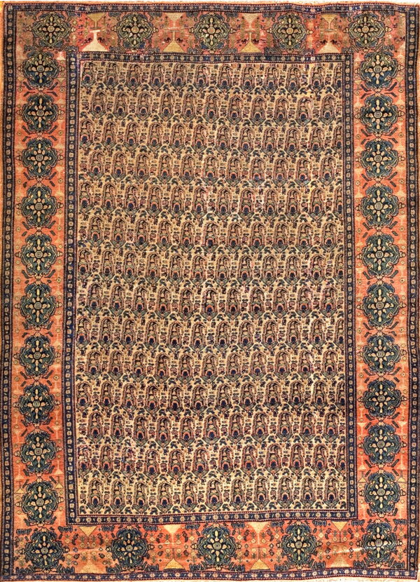 Rectangular rug with a light tan field of repeating motifs and a salmon-colored border of dark blue medallions.