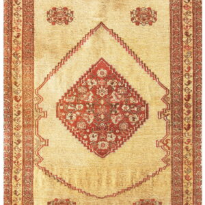 Beige rug featuring a large central red stepped medallion and complex geometric borders.