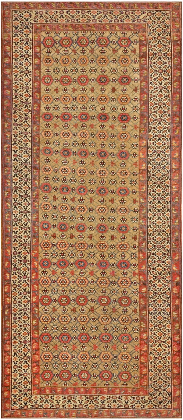Low-pile runner rug with a tan ground, red geometric floral medallions, and elaborate cream borders.