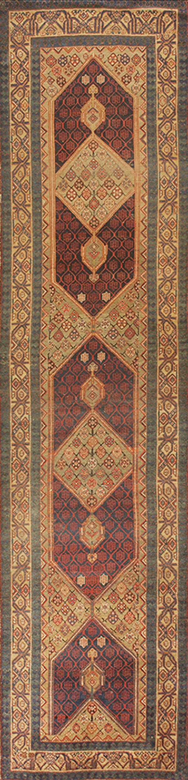 Long runner rug with complex geometric medallions in dark red, navy, beige, and slate blue borders.