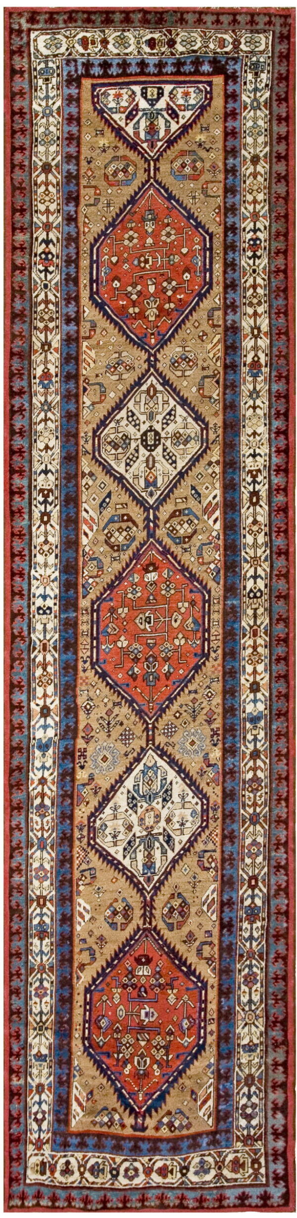Vertical runner rug showing geometric medallions in terracotta, navy, and cream on a light brown field.
