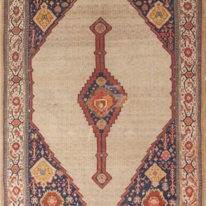 Beige rug with a large stepped diamond containing dark blue, red, and gold tribal designs.
