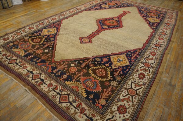 Traditional rug with a beige geometric field, red medallion, and dark navy, rust, and brown multicolored borders on wood planks.