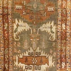 Geometric runner rug featuring a faded gray-green field bordered by rich terracotta and complex tribal patterns.