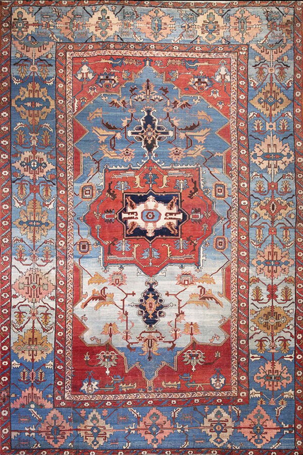 Ornate traditional rug with a central medallion pattern in striking red, deep blue, and light blue.